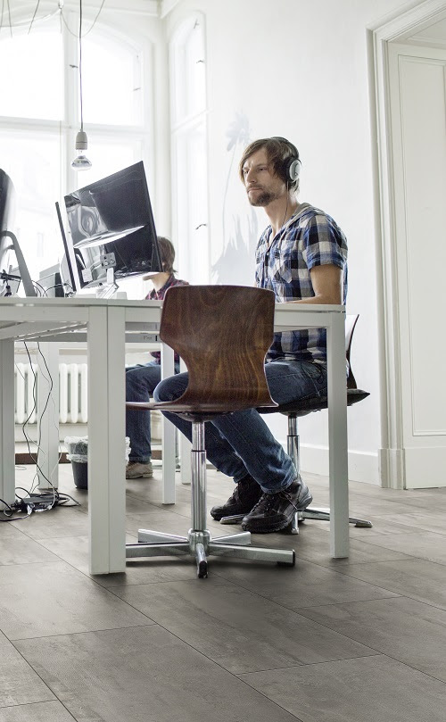 Young people sitting at a table and working on computers at startup