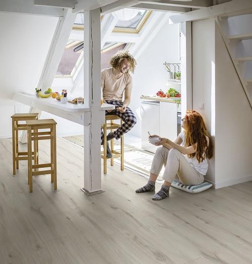 Beautiful and lovely couple enjoying their time by living together in a new apartment, eating breakfast in the morning.